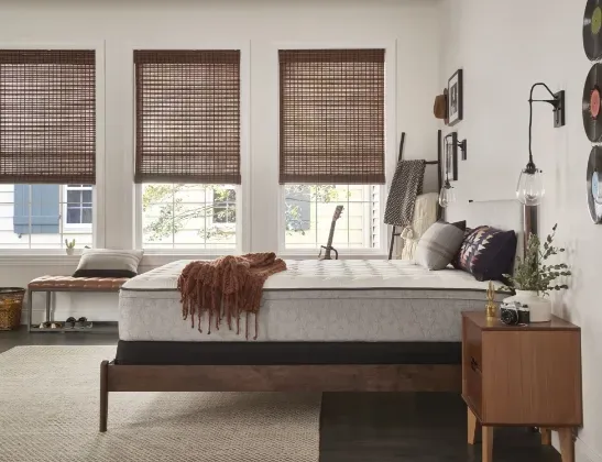 bare seely mattress on top of dark wood bedstand